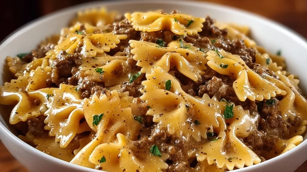 Creamy Parmesan garlic beef bowtie pasta topped with fresh herbs