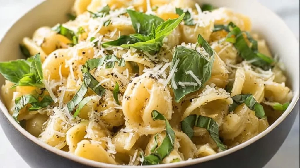 Basil Lemon Pasta Salad with fresh herbs and lemon zest in a bowl