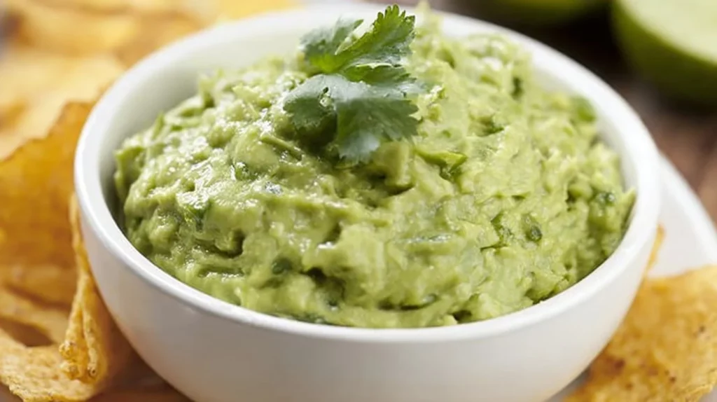 Delicious bowl of homemade guacamole with fresh ingredients