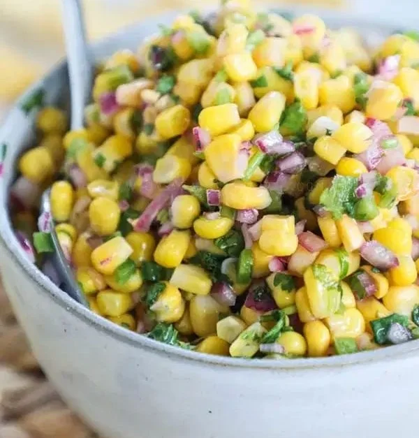 Delicious chipotle corn salsa in a bowl with fresh ingredients