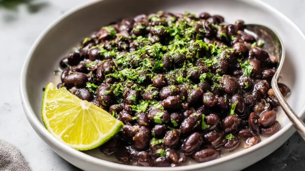 Bowl of flavorful Mexican Black Beans served with spices and herbs