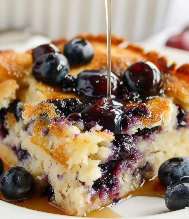 Buttermilk and blueberry pancake bake served in a baking dish, perfect for breakfast.