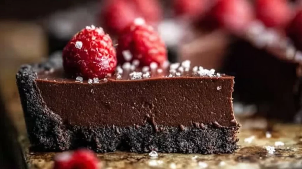 Delicious chocolate raspberry tart topped with fresh raspberries and chocolate ganache.