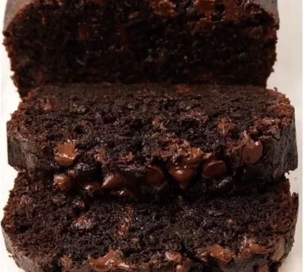 Sliced Chocolate Zucchini Bread with chocolate chips and a moist texture.