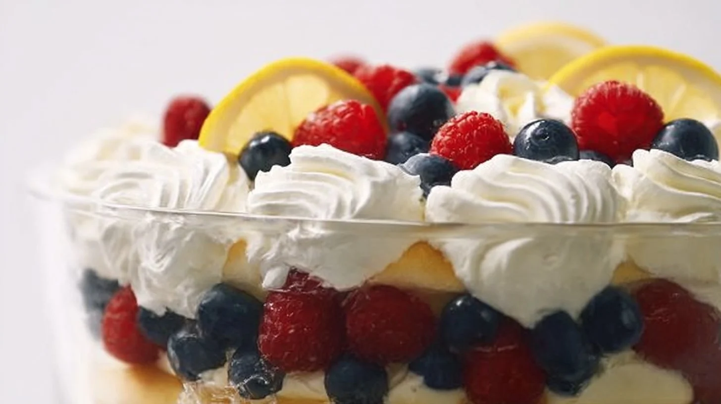 Delicious Lemon Berry Trifle dessert with layers of lemon cream and fresh berries.