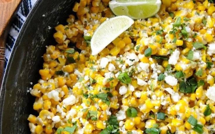 Skillet Mexican Street Corn topped with cheese and spices