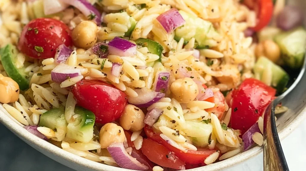 A colorful bowl of the best Italian Orzo Salad with fresh vegetables and herbs