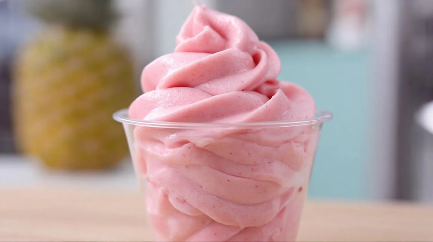 Delicious Strawberry Dole Whip served in a bowl with fresh strawberries.