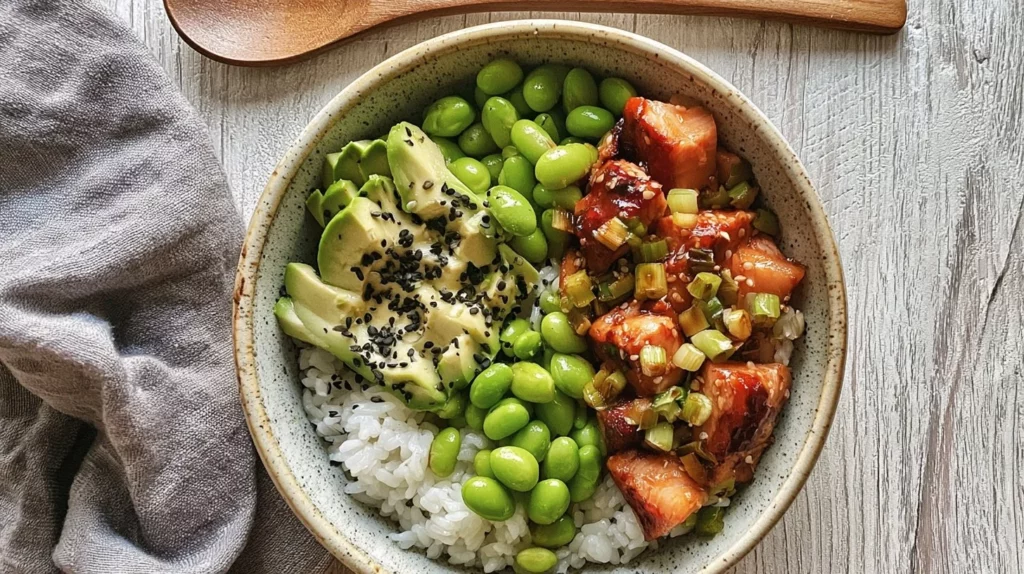 Delicious Teriyaki Salmon Sushi Bowl with rice, vegetables, and sushi sauce.